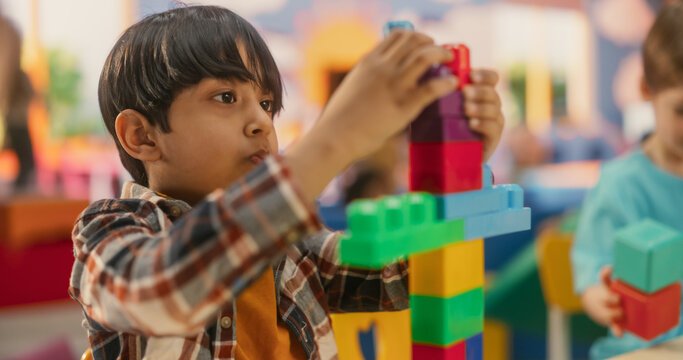 Child building with colourful blocks at pre-school